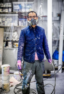 The artist Gordon Cheung wearing a mask ready to spray paint a new picture.