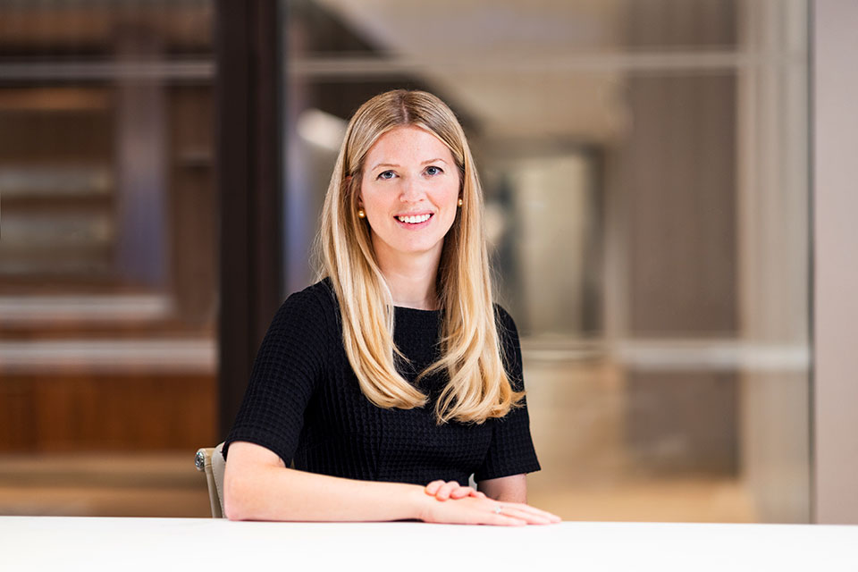 Corporate Executive Headshots by Richard Boll in London. Image of a businesswoman at her desk.