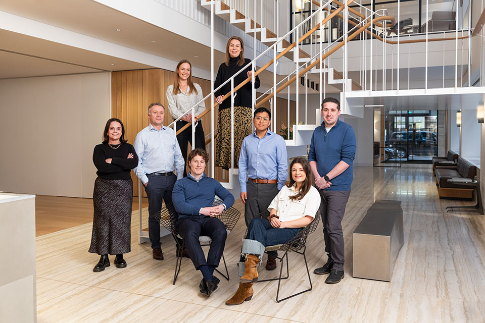 Corporate Group Portrait Photography by Richard Boll for Derwent London. The team in the lobby and on the stairs.