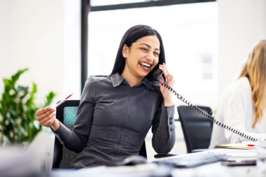 A woman talking on the phone by Richard Boll for Park Avenue Recruitment.