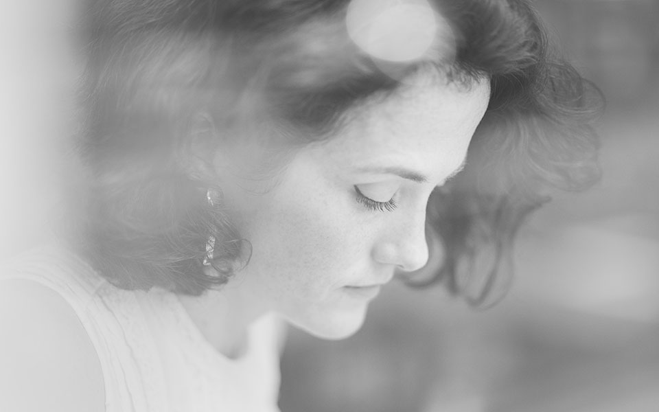 A close up portrait of the artist Marie Harnett drawing in a cafe in London. Photo by Richard Boll.