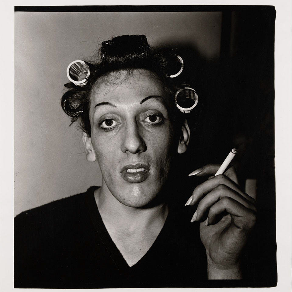 A young man in curlers at home on West 20th Street, N.Y.C. 1966 by Diane Arbus.