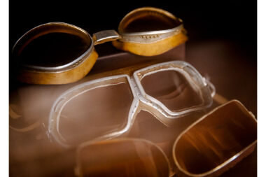 Antique goggles in a display case in the library of Wadi Sabarah Lodge, Egypt, by photographer Richard Boll.